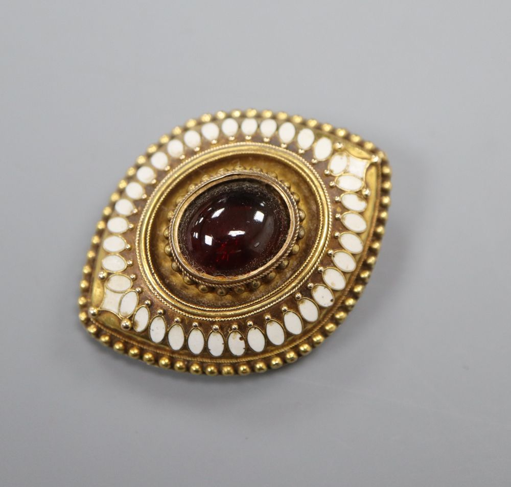An Etruscan Revival yellow metal, white enamel and garnet navette-shaped brooch with glazed back